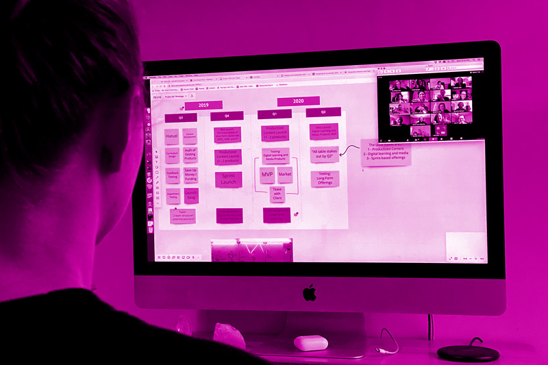 A person looking at a computer screen with a virtual whiteboard and live collaborators visible