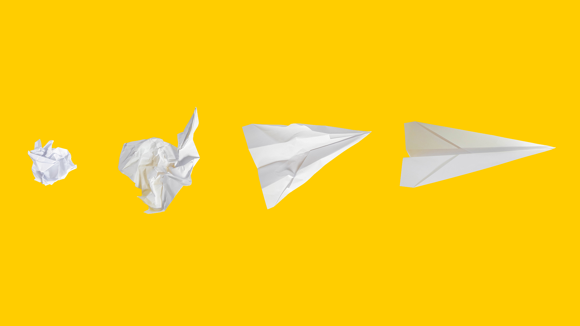 A balled up piece of paper transforms into a paper airplane